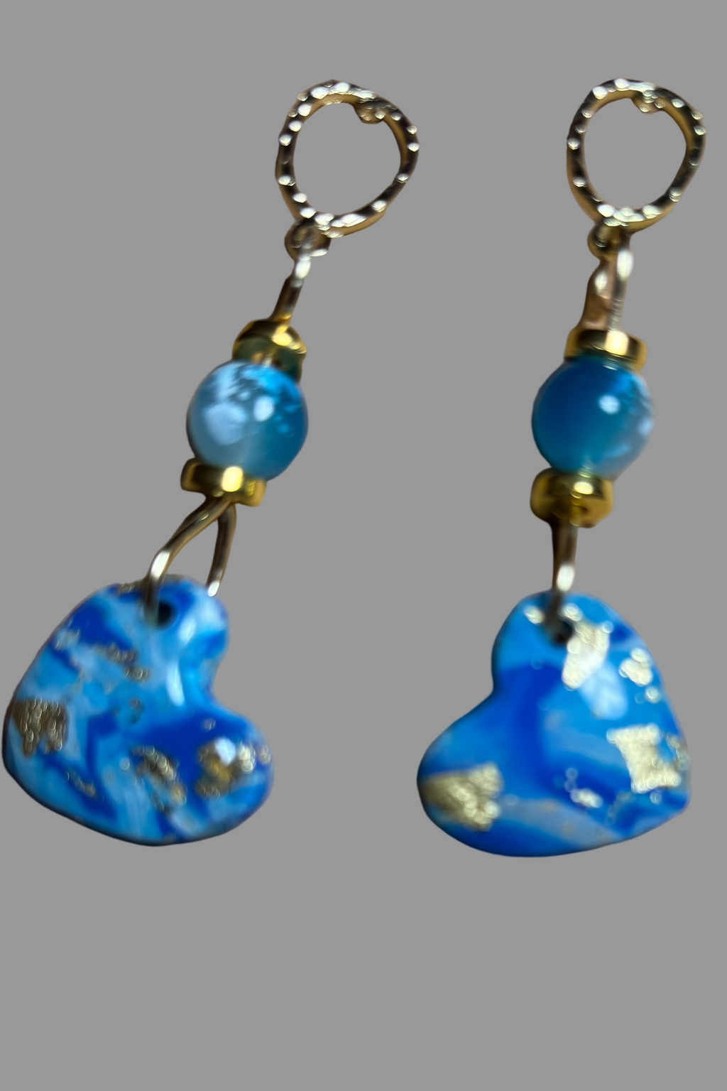 Pair of blue heart-shaped earrings with gold accents 