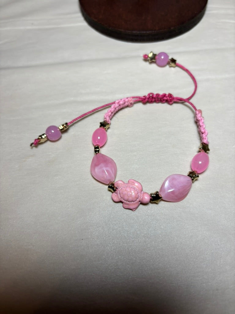 Pink beaded bracelet with floral design