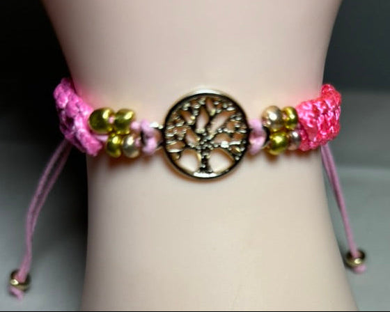 Bracelet with pink cord and gold beads