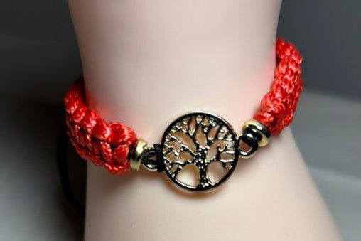 Red braided bracelet with a tree of life charm 