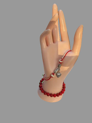 Red beaded bracelet with silver charms 