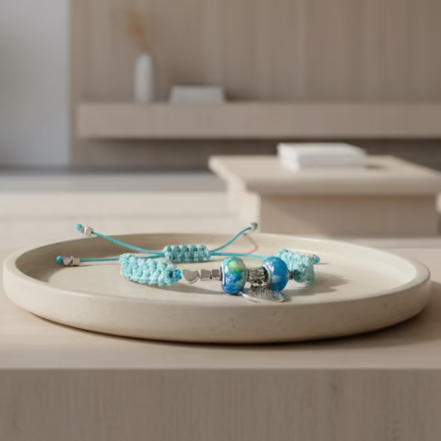 Turquoise beaded bracelet on a white plate with a neutral background