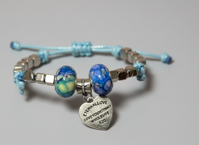 Bracelet with blue beads and a silver charm on a gray background