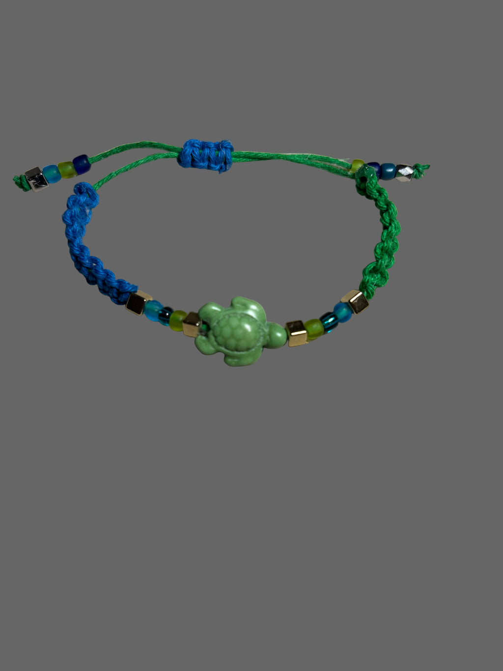 Green and blue beaded bracelet with a green frog charm 