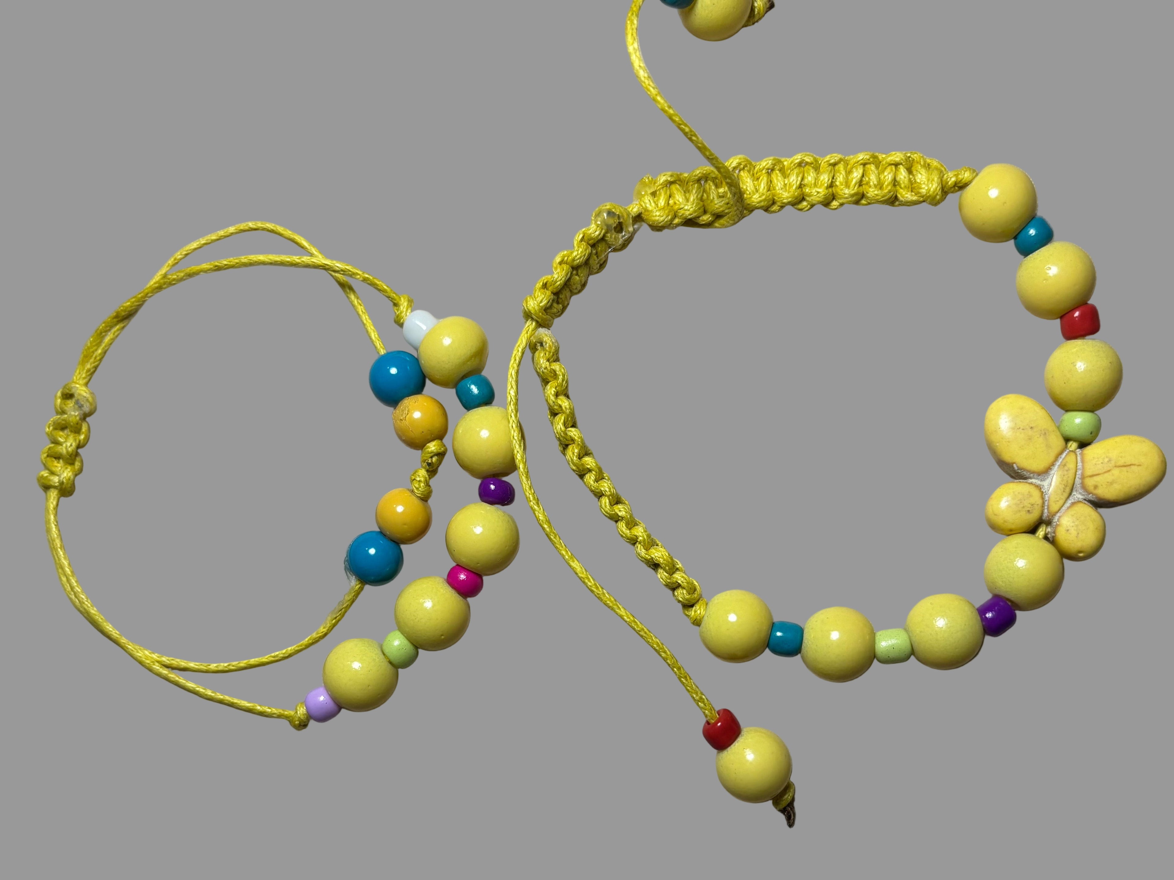 Two yellow beaded bracelets with colorful beads 