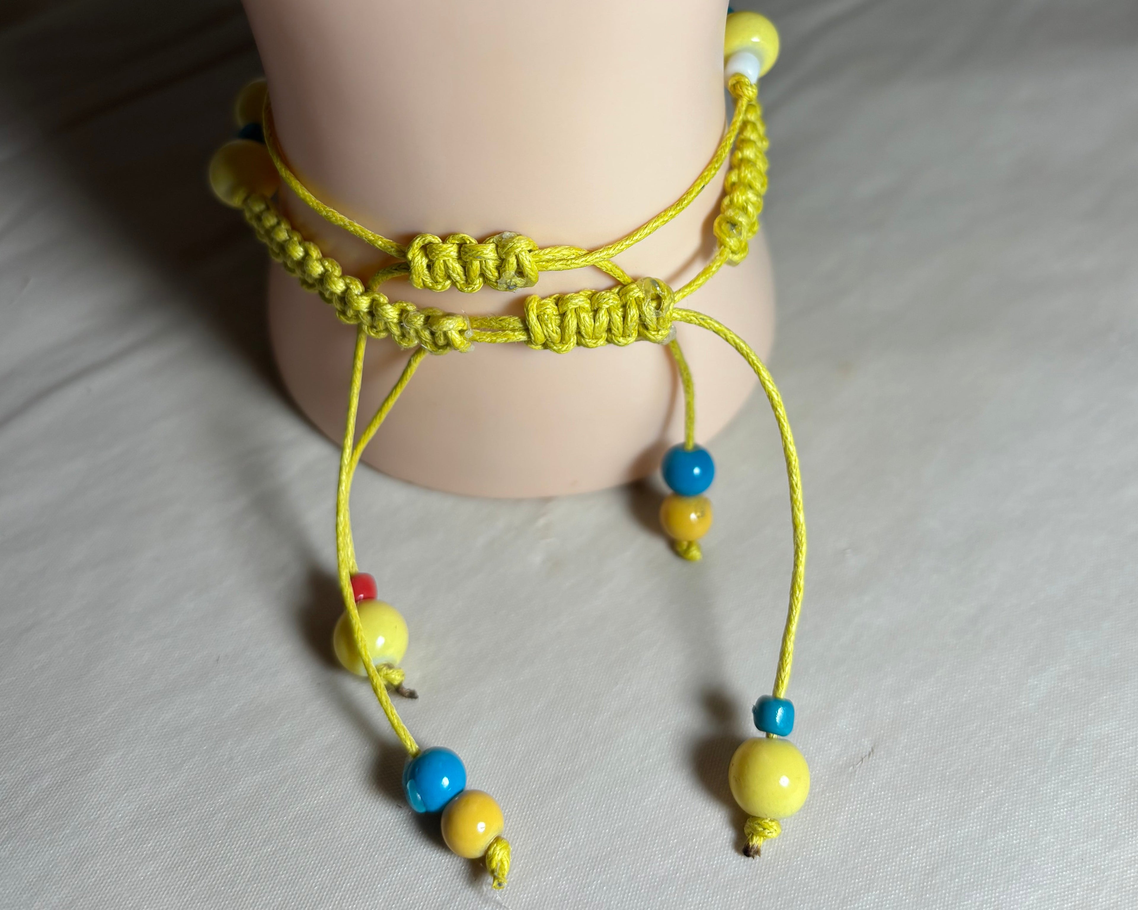 Yellow anklet with colorful beads 